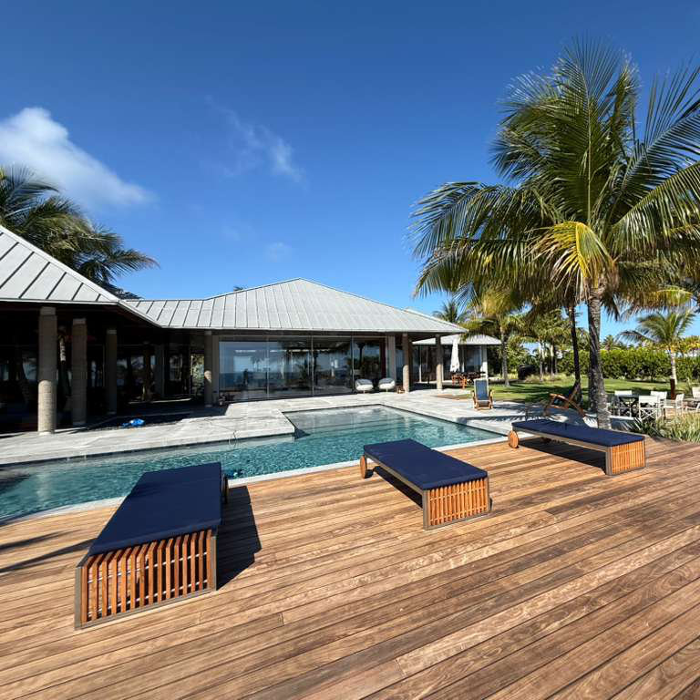 A view of a swimming pool surrounded by palm trees